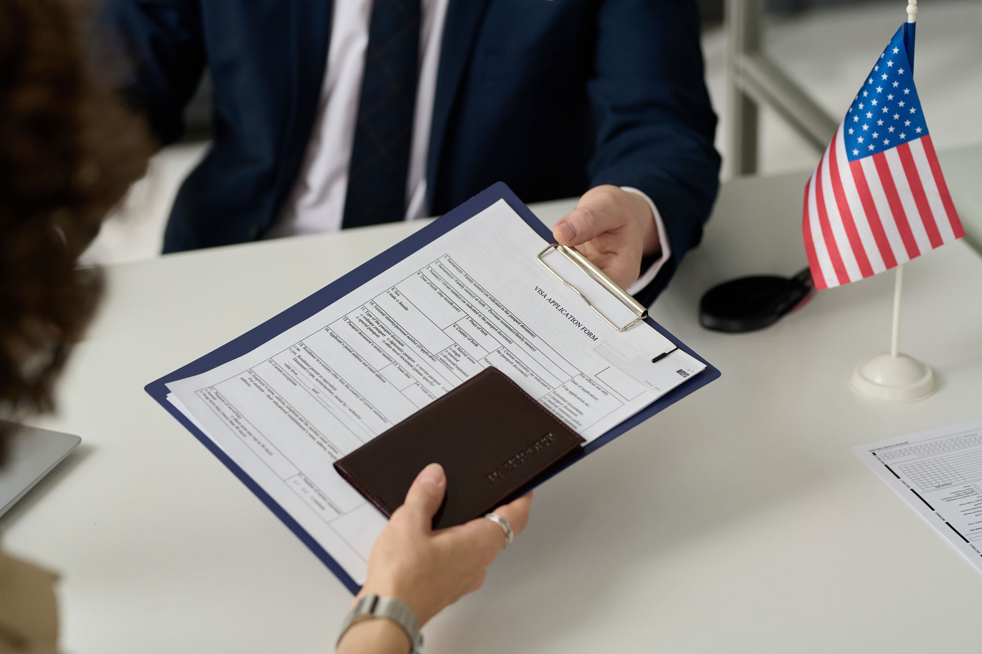 Two people passing documents to be notarized